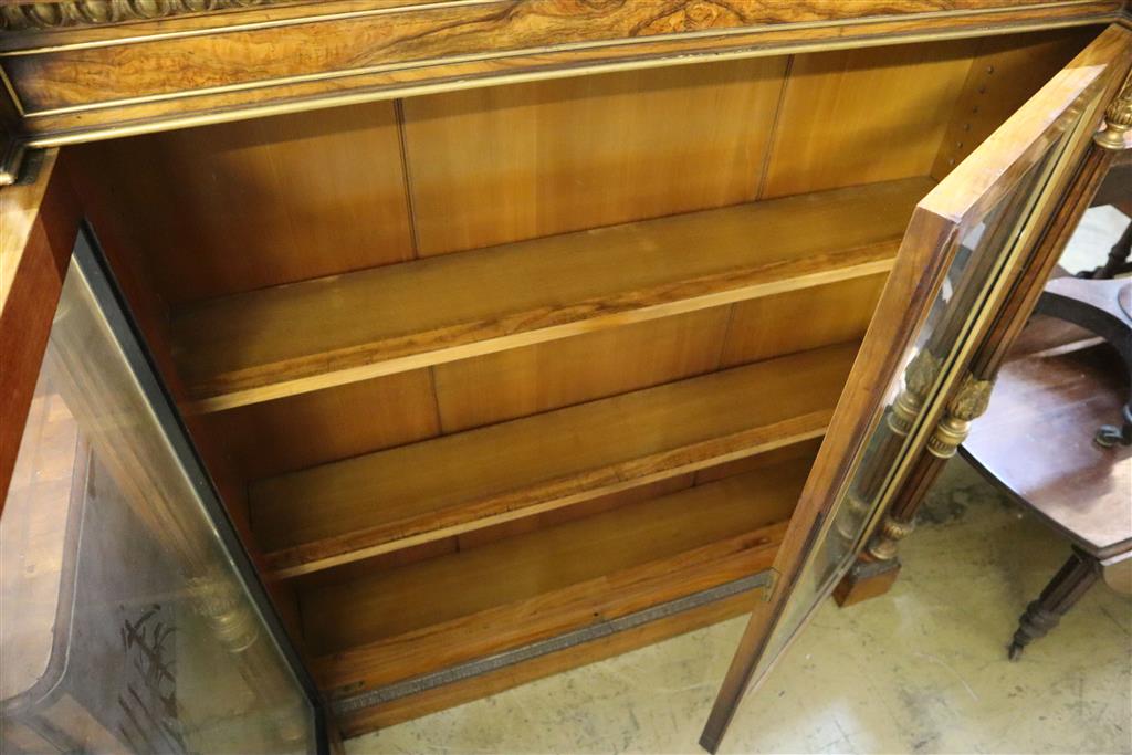A Victorian parcel gilt walnut inverse breakfront bookcase, width 112cm, depth 27cm, height 118cm